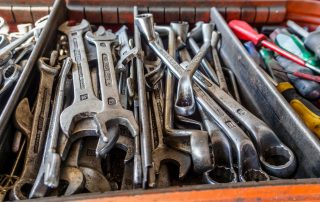 a box filled with lots of wrenches and other tools
